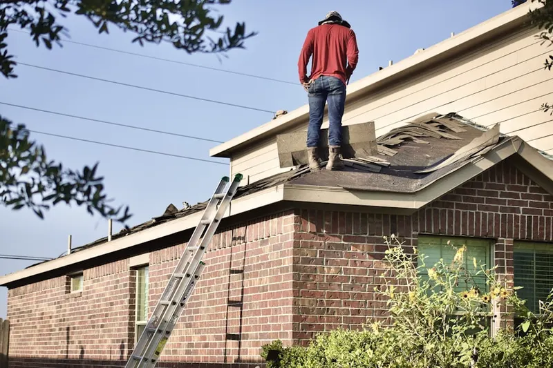 Professional roofer working on a residential roof in Corinne